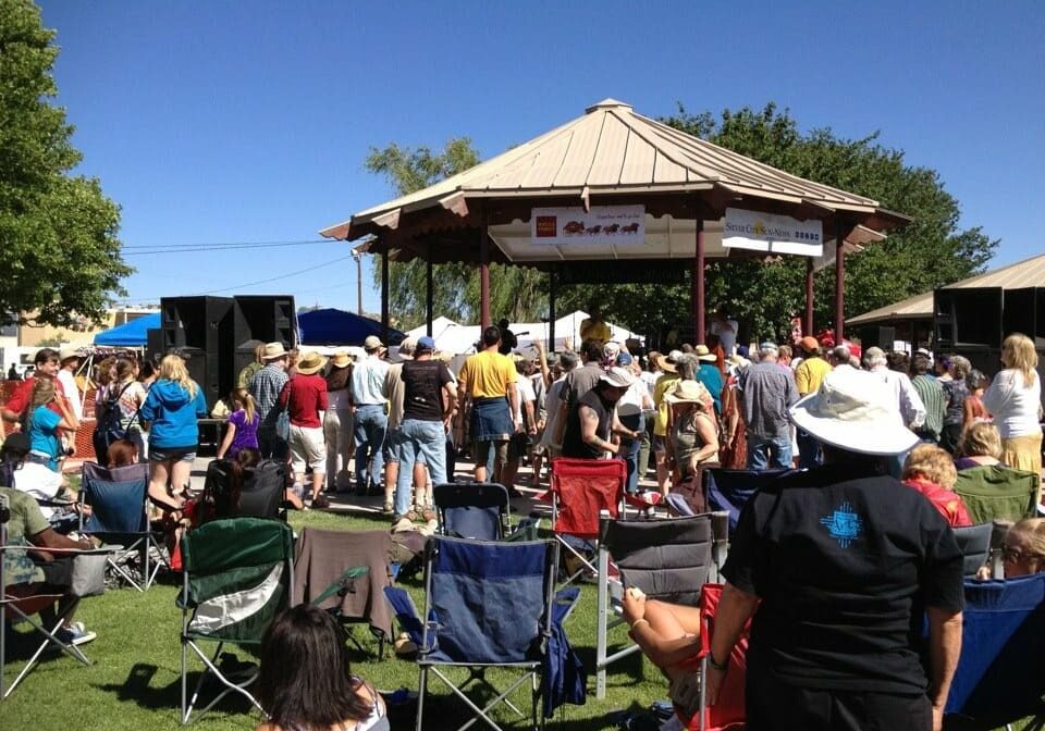 A crowd of people gathered around an outdoor pavilion.